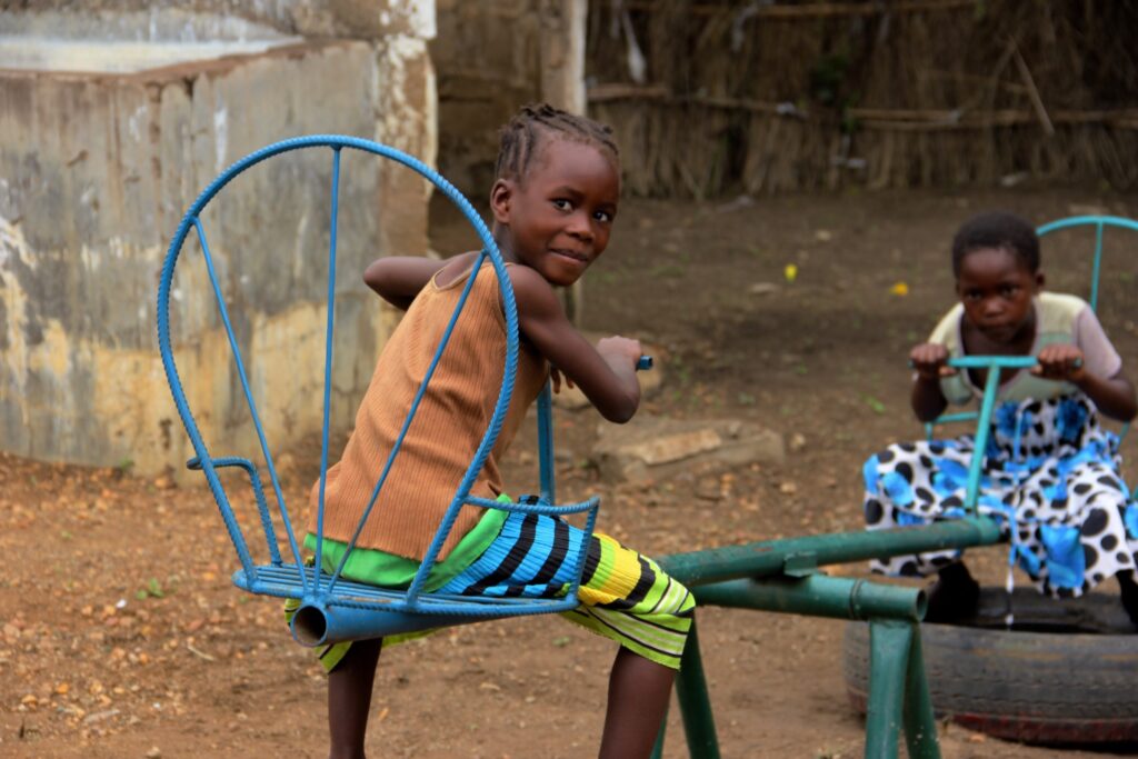 Two children play on a see saw