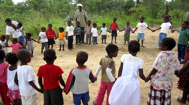 Children holding hands in a circle.