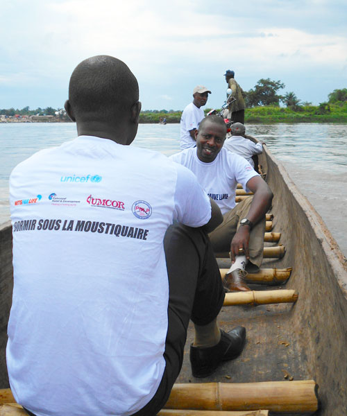 Malaria Control Agents cross Congo River in canoes