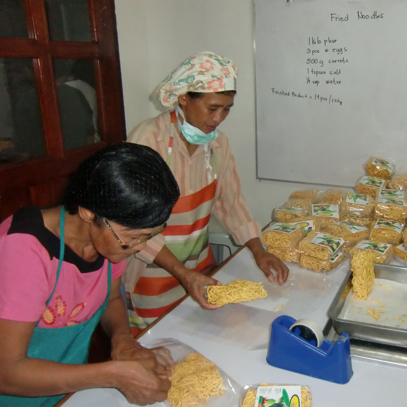 Making vegetable noodles for relief packs in the Philippines